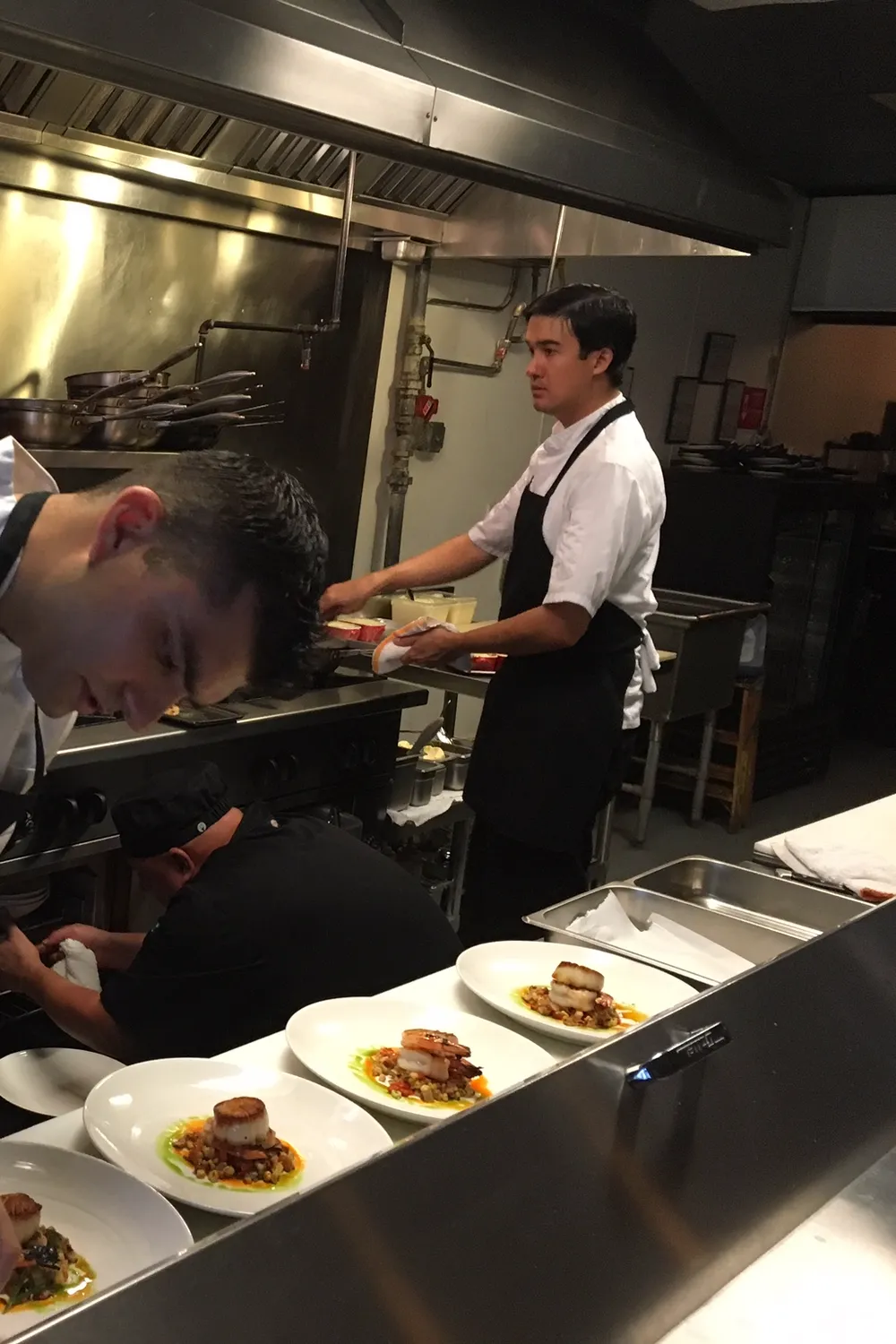 Plates lined up on the pass in Petar's open kitchen